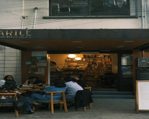 Person working on a laptop at a cafe in Mexico City with natural light